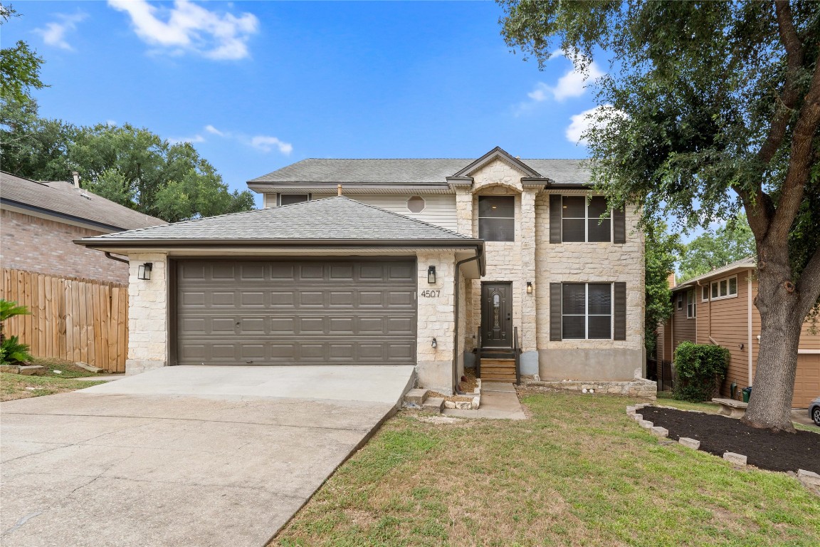 a front view of a house with a yard and garage