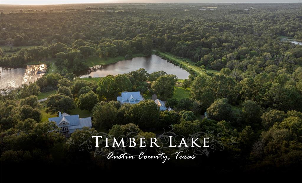 an aerial view of house with yard and lake