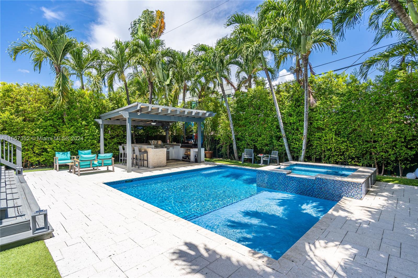 a view of a swimming pool with chairs in patio