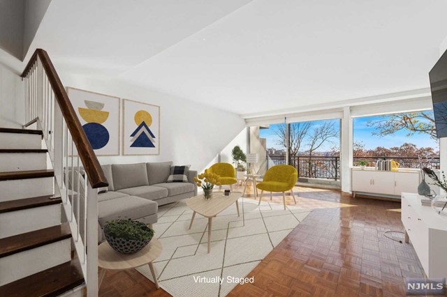 a living room with furniture and a floor to ceiling window