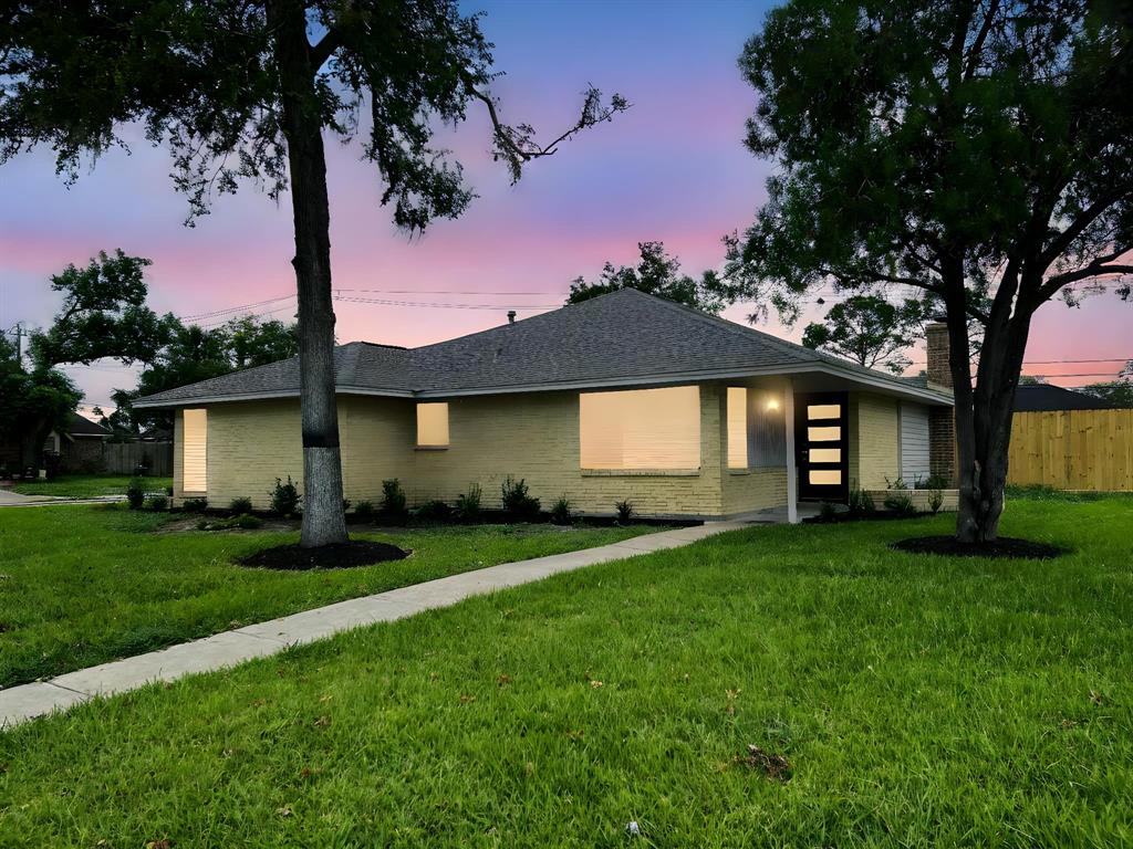 Welcome to your picture-perfect home, boasting a beautifully landscaped frontage under a serene sunset sky.