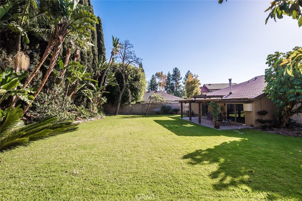 a view of a house with a yard and sitting area