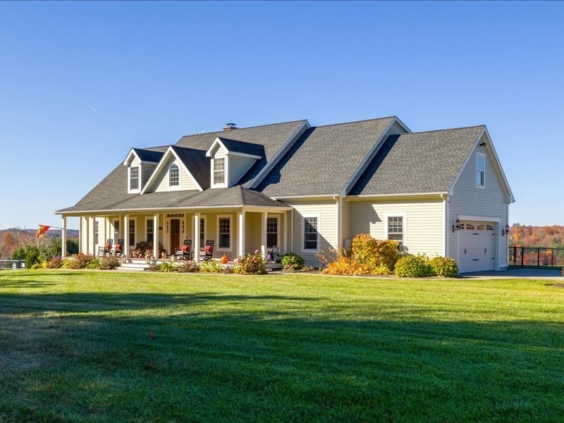 a front view of a house with a garden