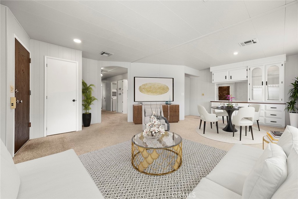 a living room with furniture and a view of kitchen