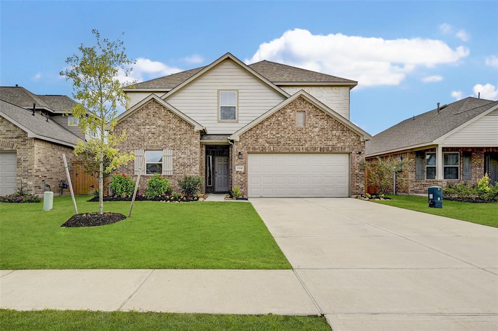 a front view of a house with a yard and garage