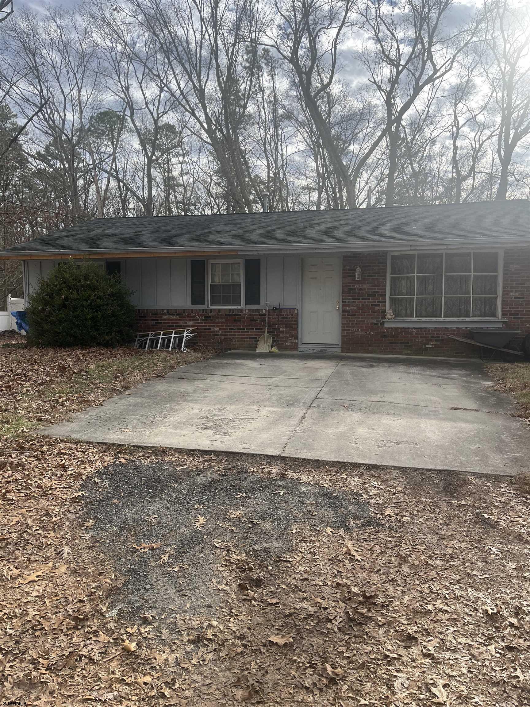 a front view of a house with a yard and a garage