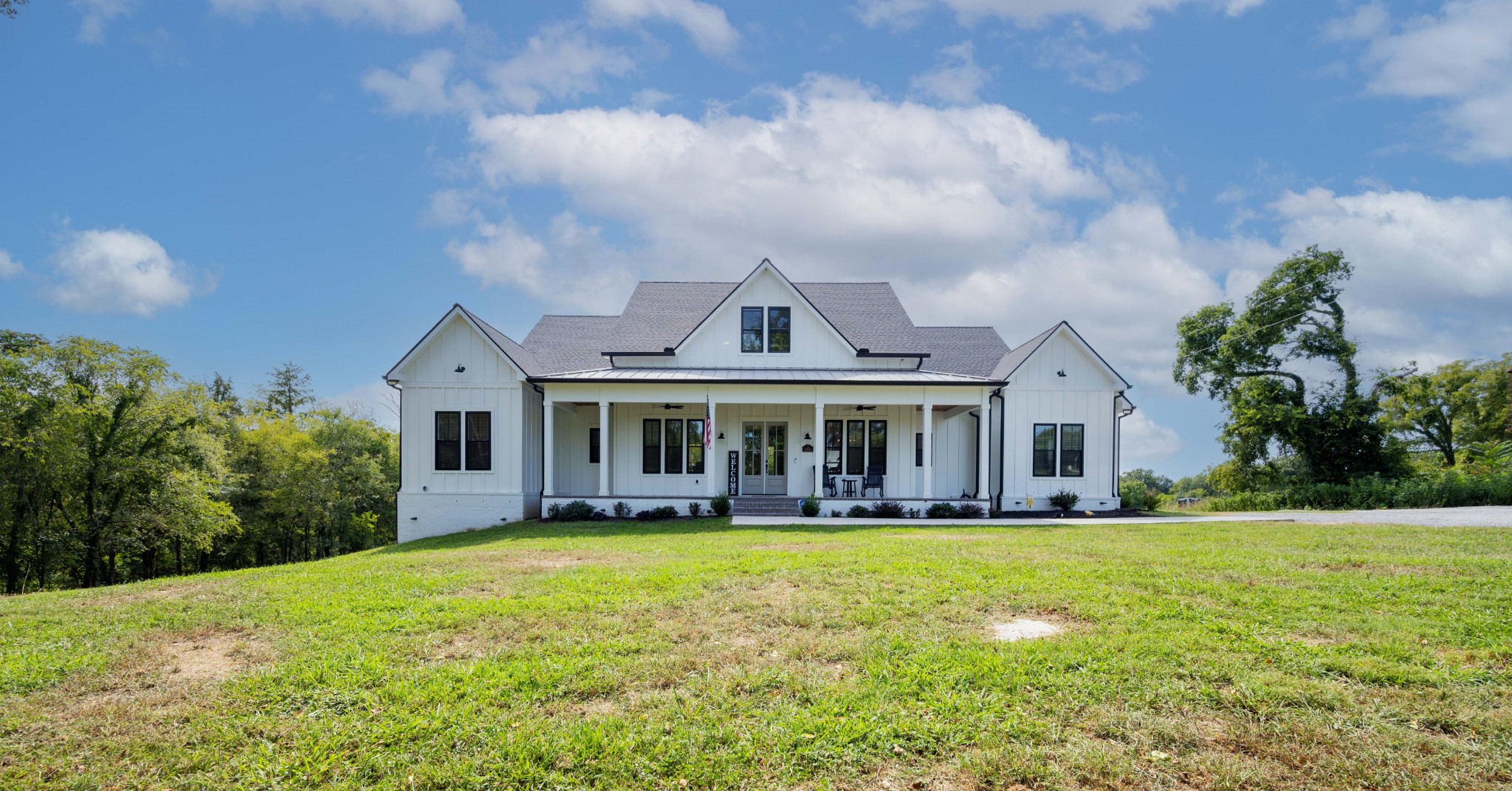 a front view of house with yard and green space