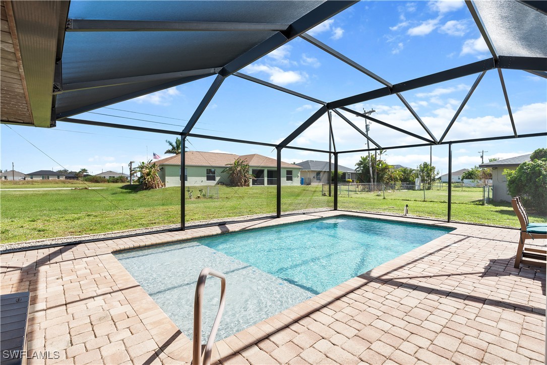 a view of swimming pool with deck and yard