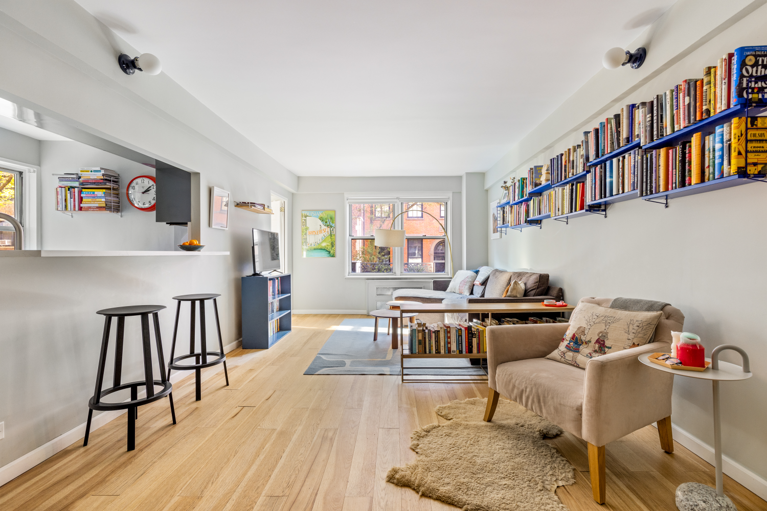 a living room with furniture and a book shelf