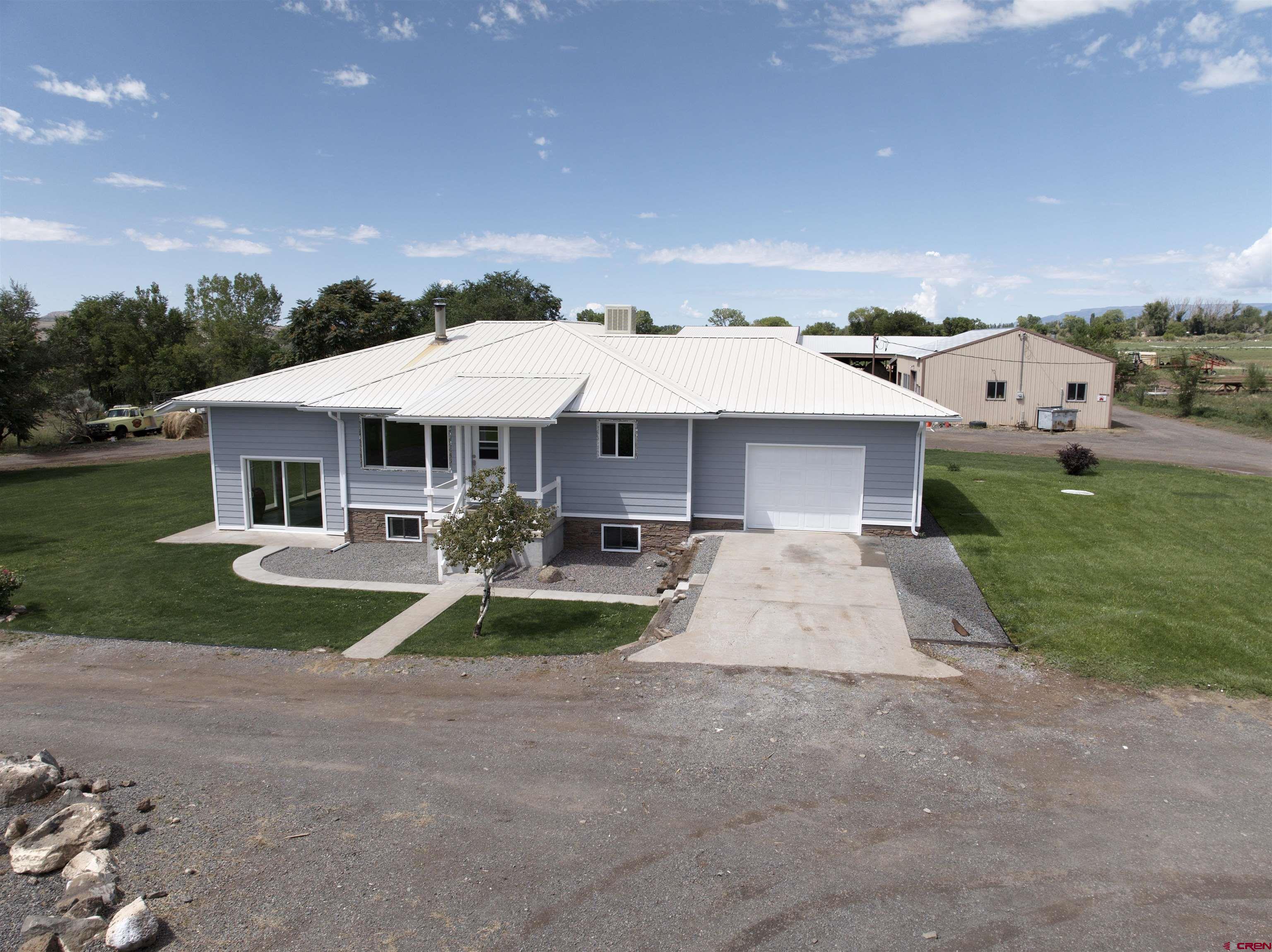 a front view of a house with yard patio and green space