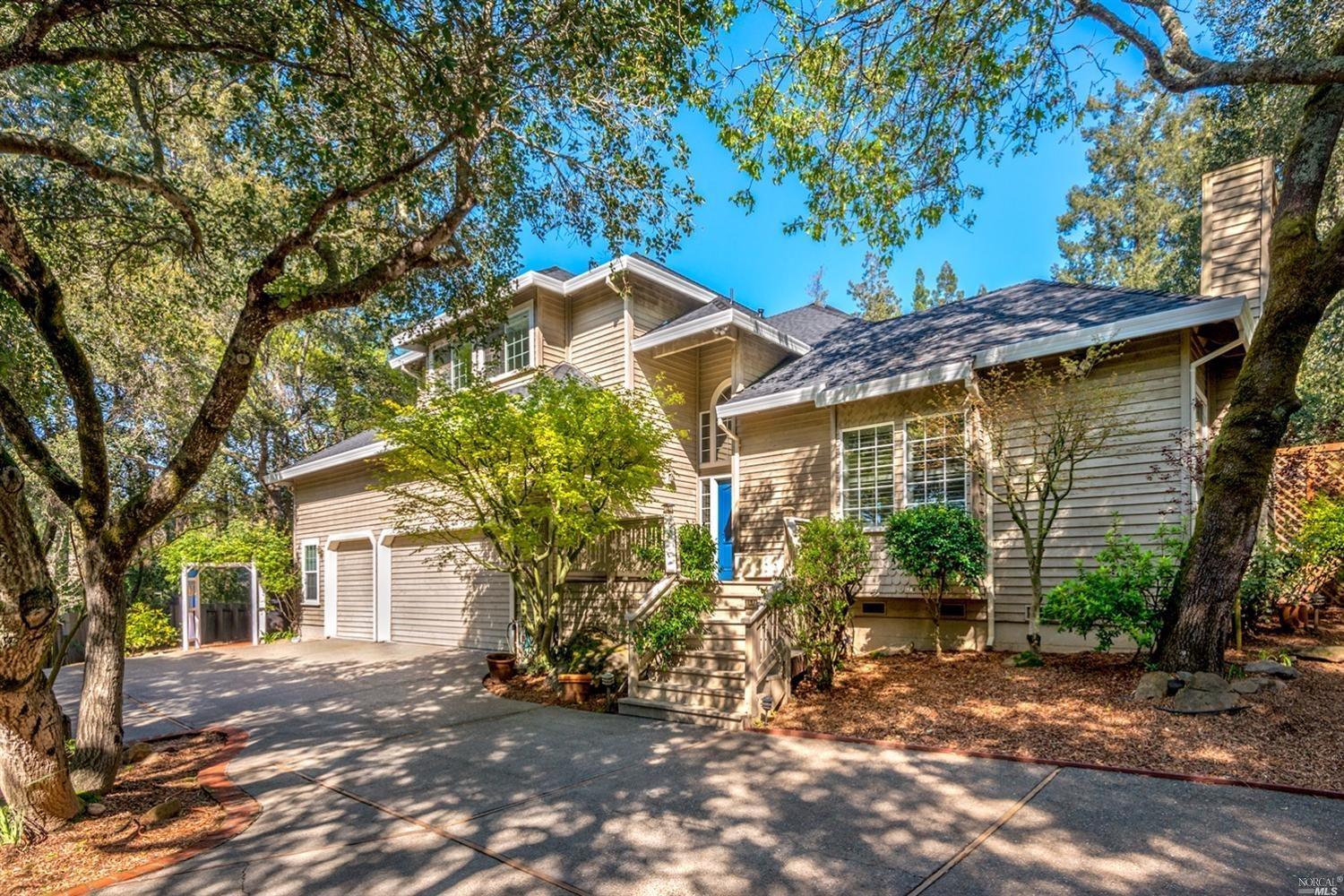 a view of a house with a tree in the background