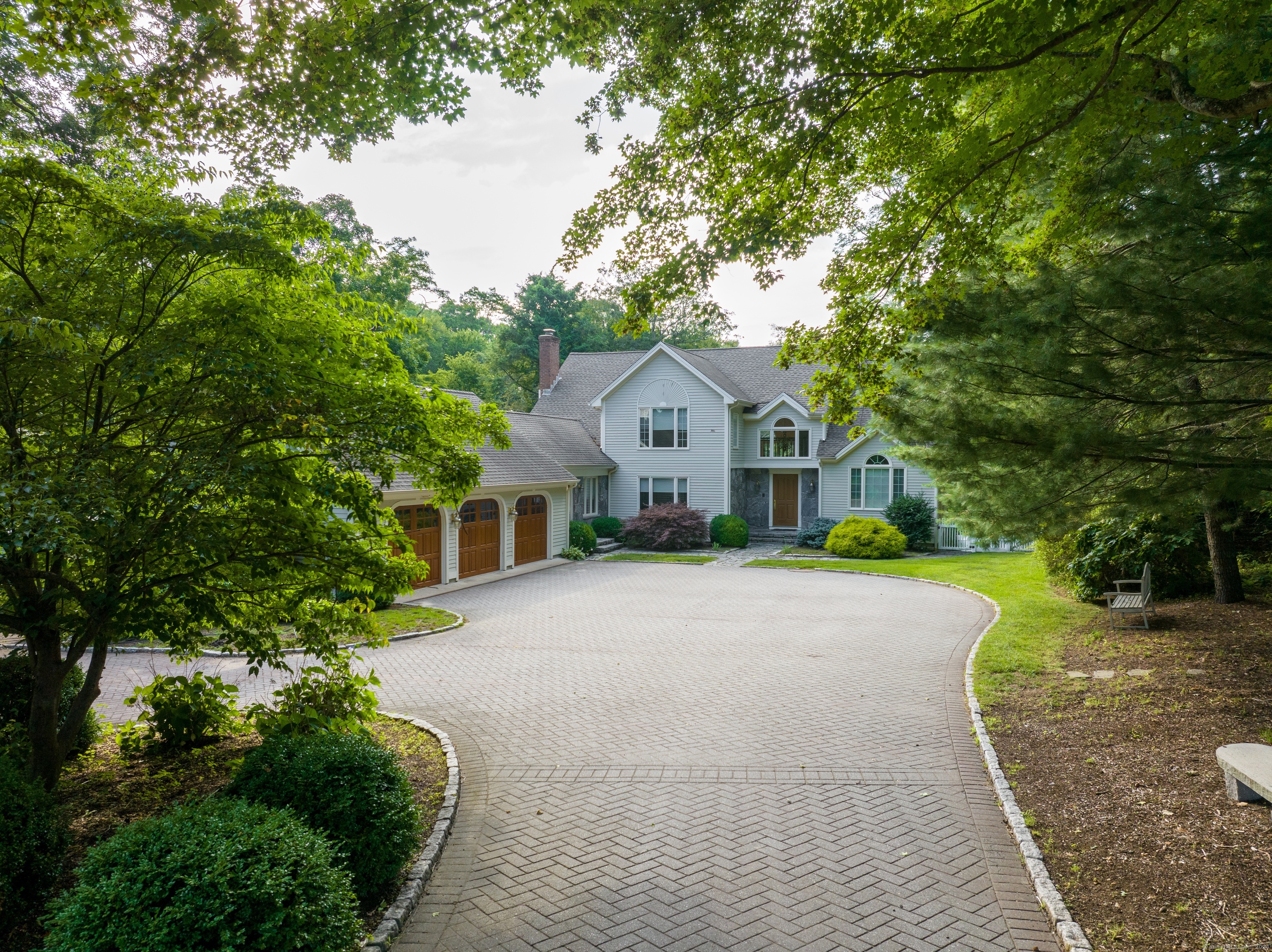 a front view of house with yard and green space