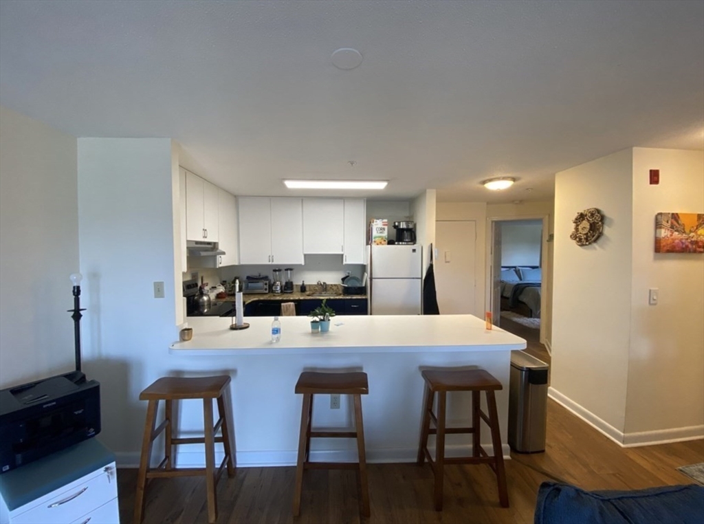 a large kitchen with dining table and chairs