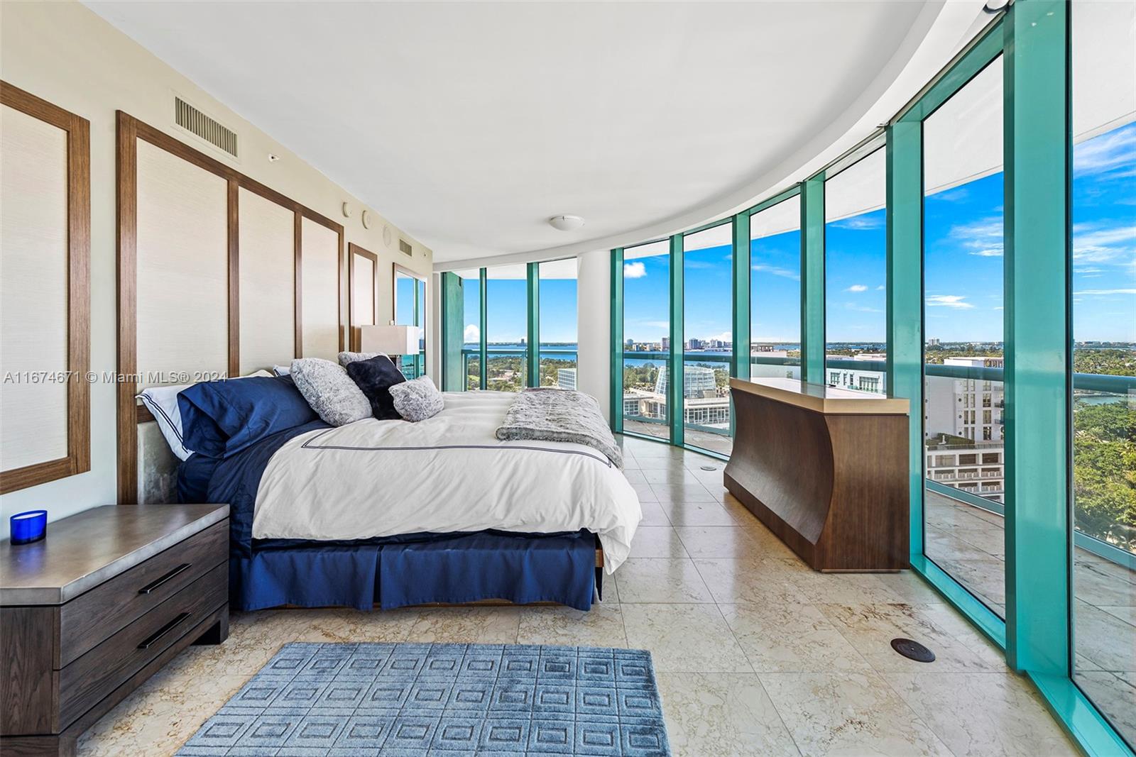 a bedroom with a large bed and a balcony view