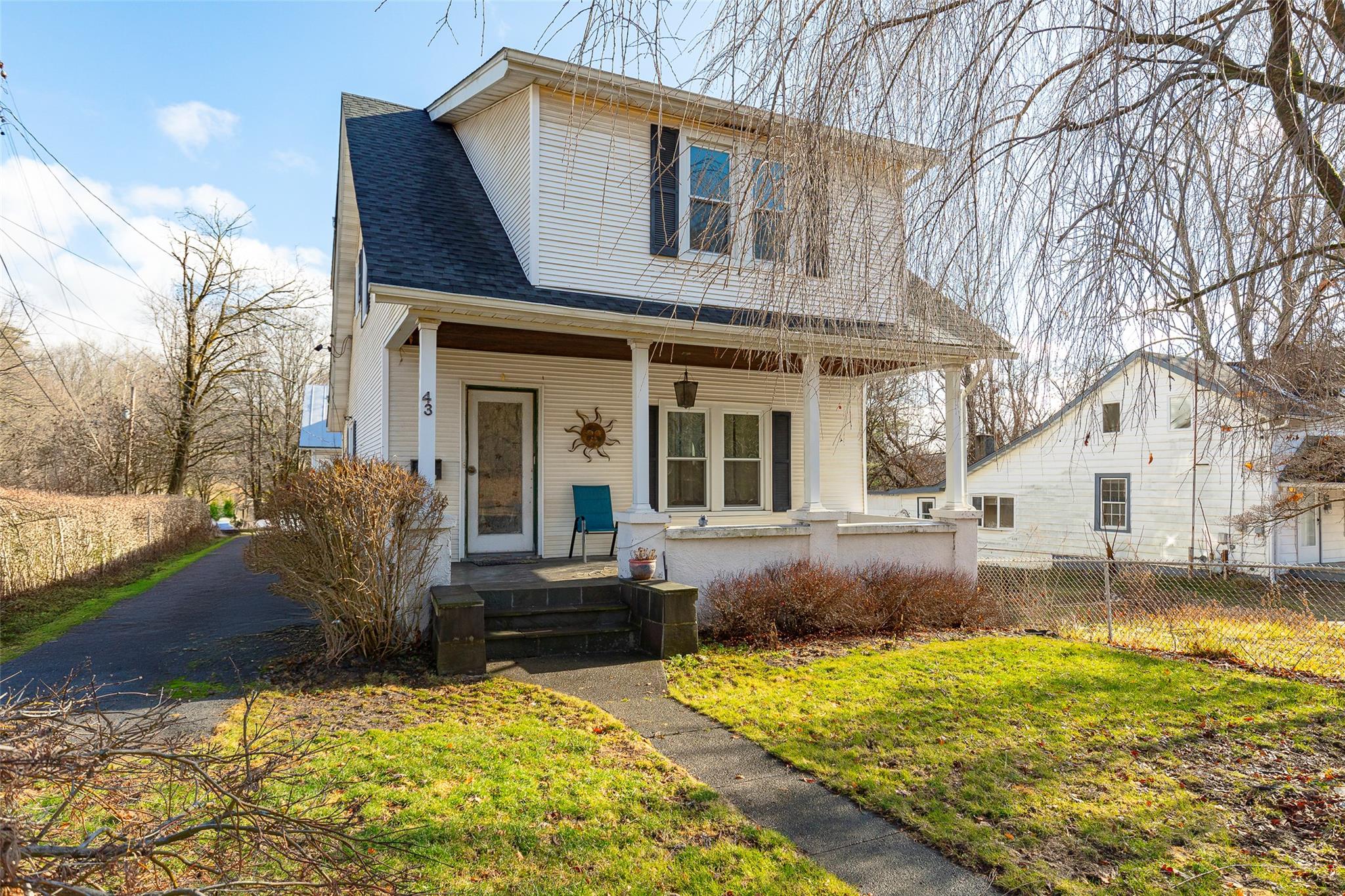 View of front facade with a porch and a front lawn