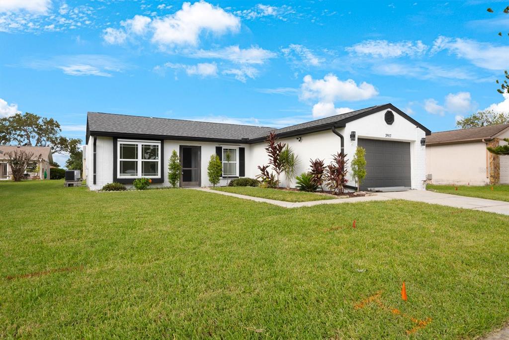 a front view of house with yard and green space