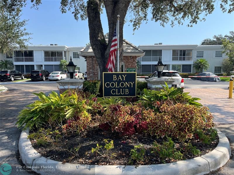 a sign that is sitting in front of a bunch of flowers