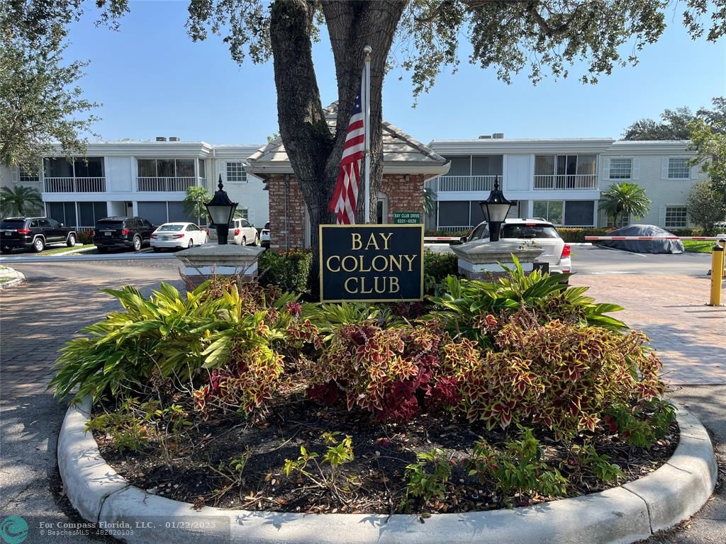 a sign that is sitting in front of flowers