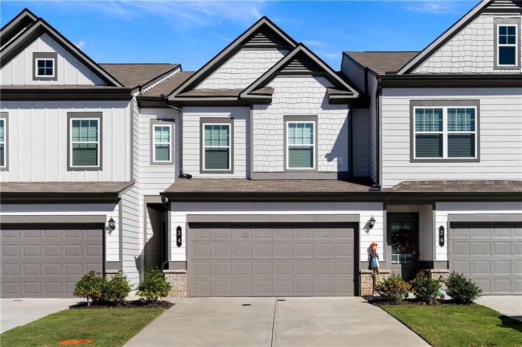 a front view of a house with a yard and garage