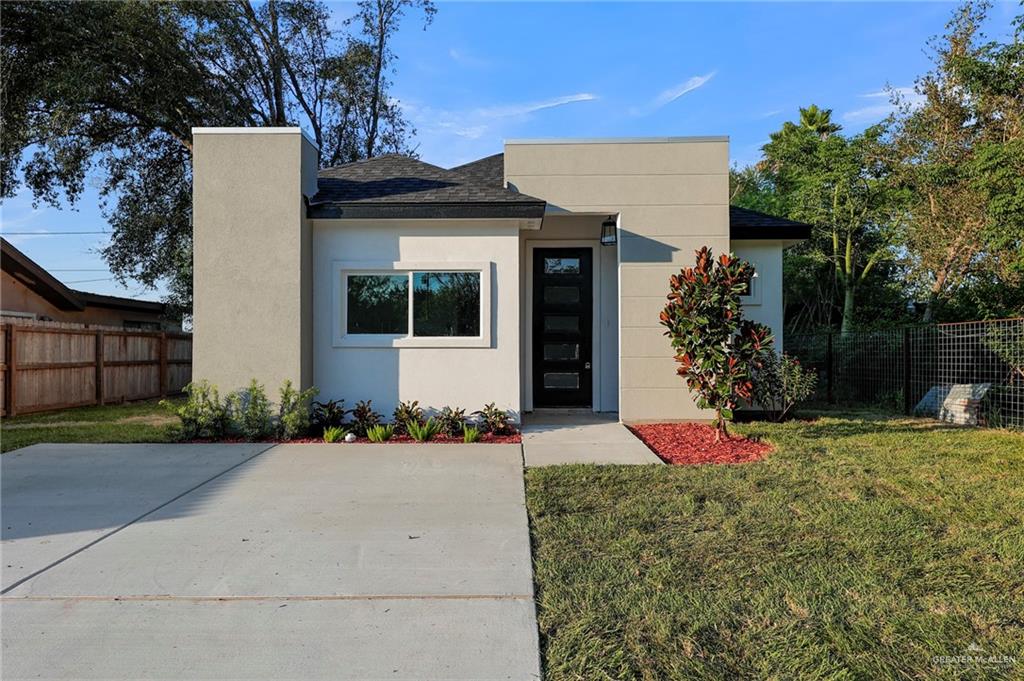 View of front of home with a patio and a front lawn