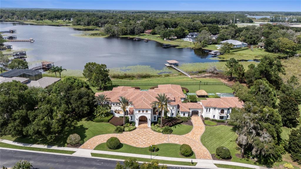 an aerial view of a house with garden space and lake view