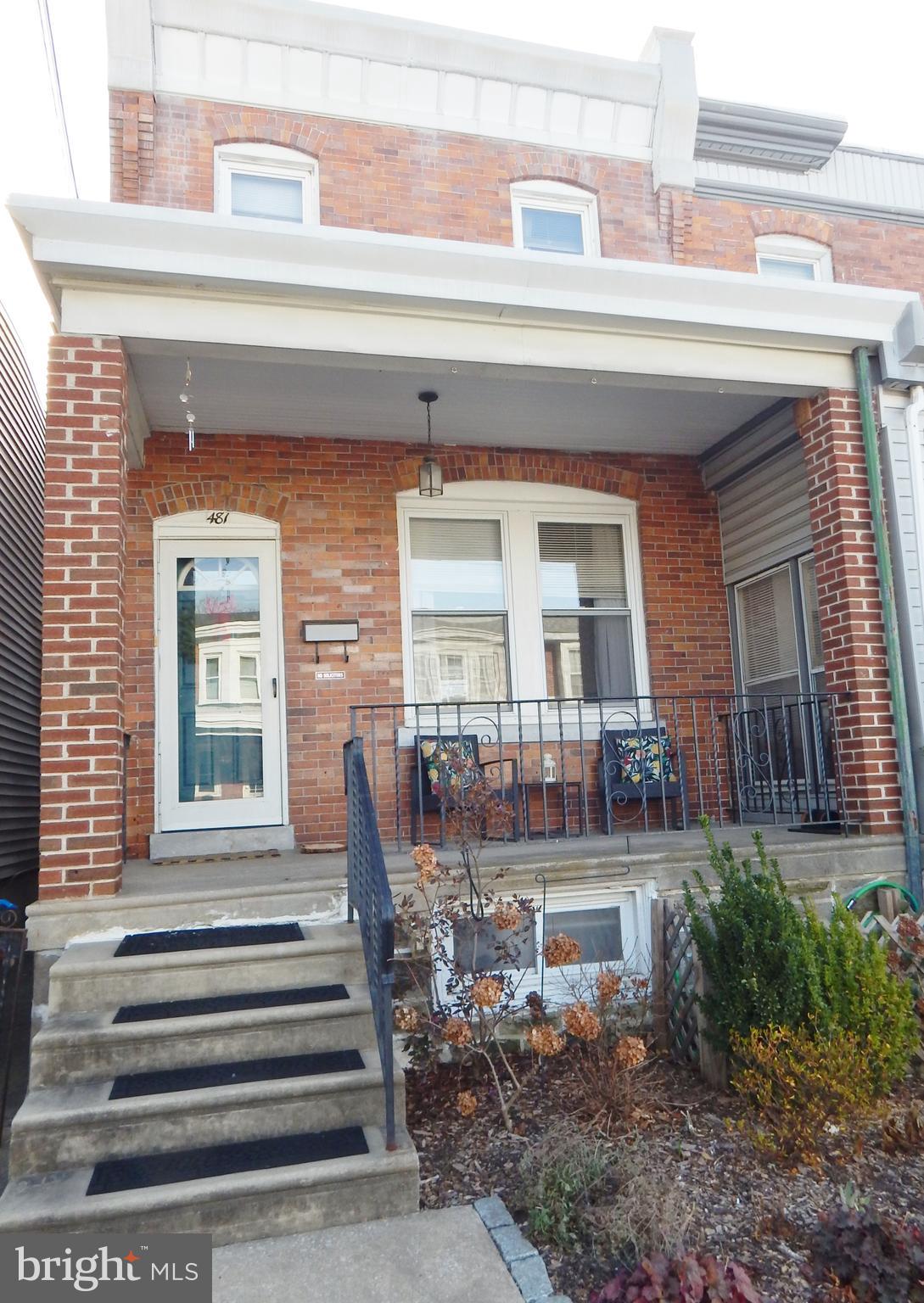 a front view of a house with a outdoor seating