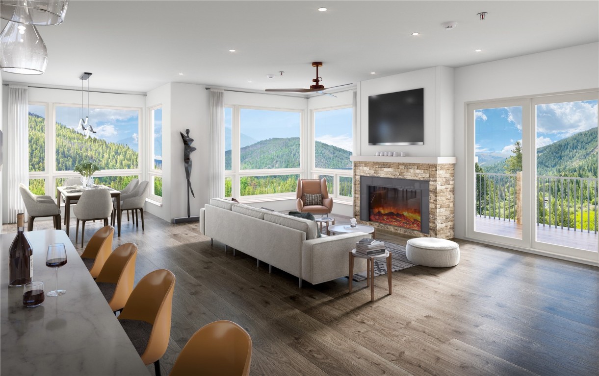 a living room with furniture fireplace and a large window