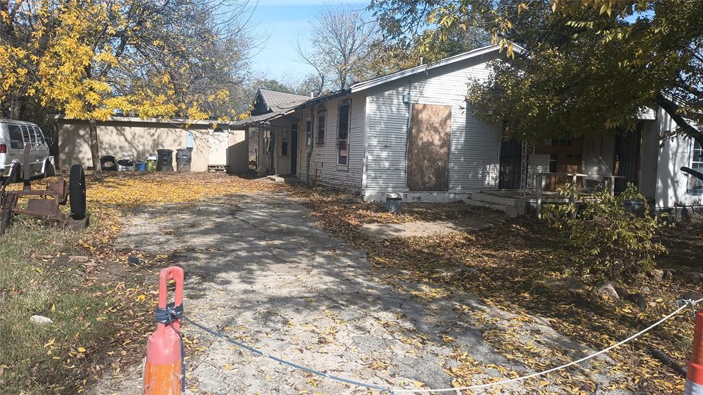 a backyard of a house with table and chairs