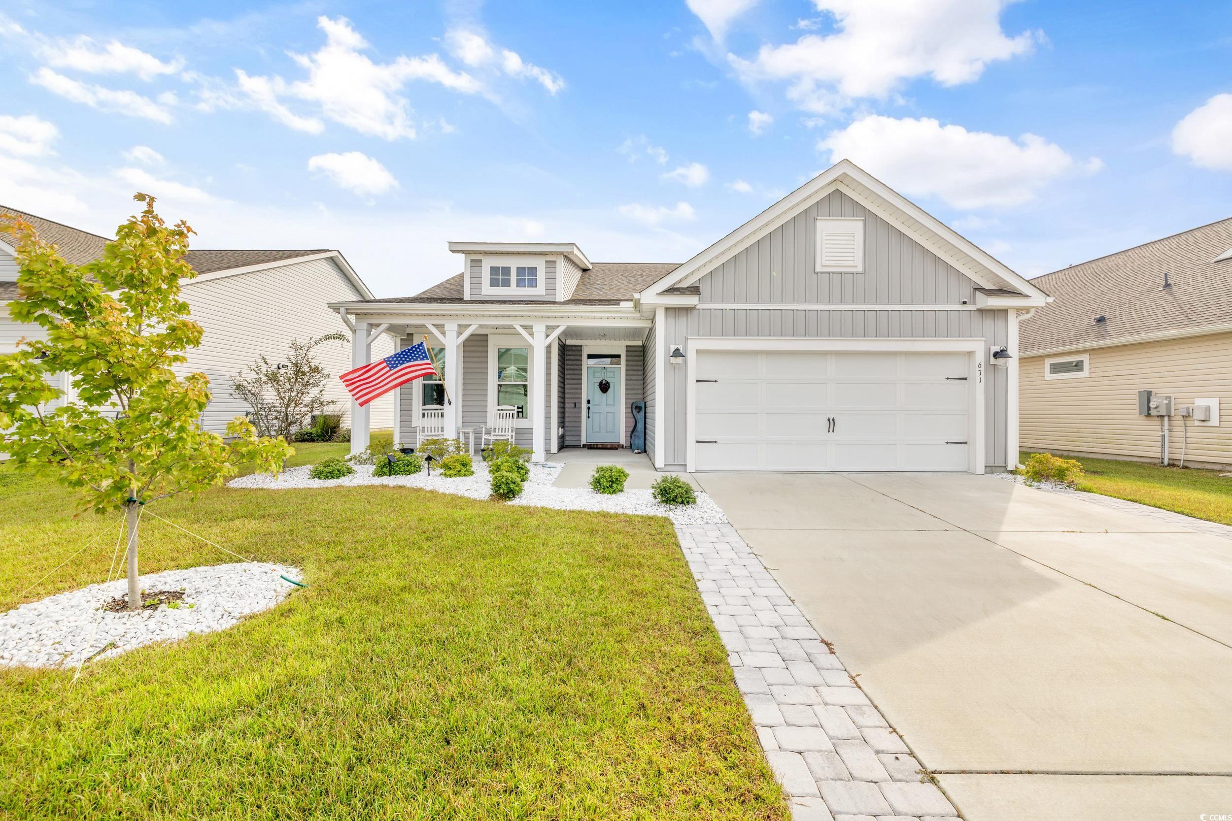 View of front of house with a garage, a porch, and