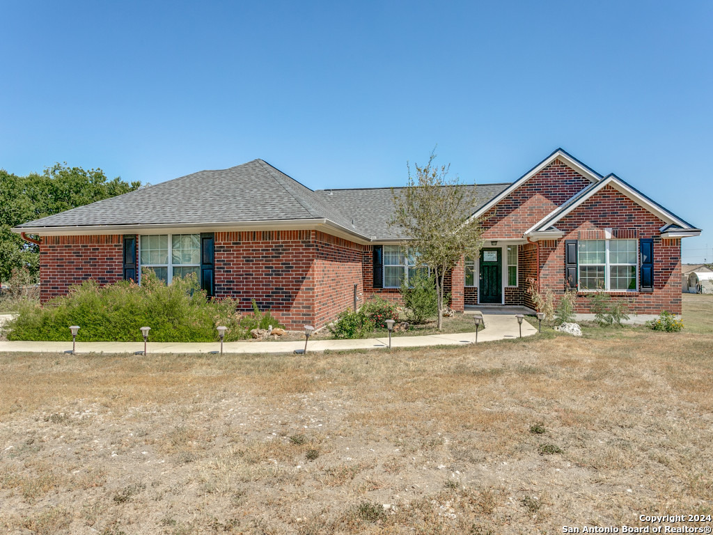 a front view of a house with a garden