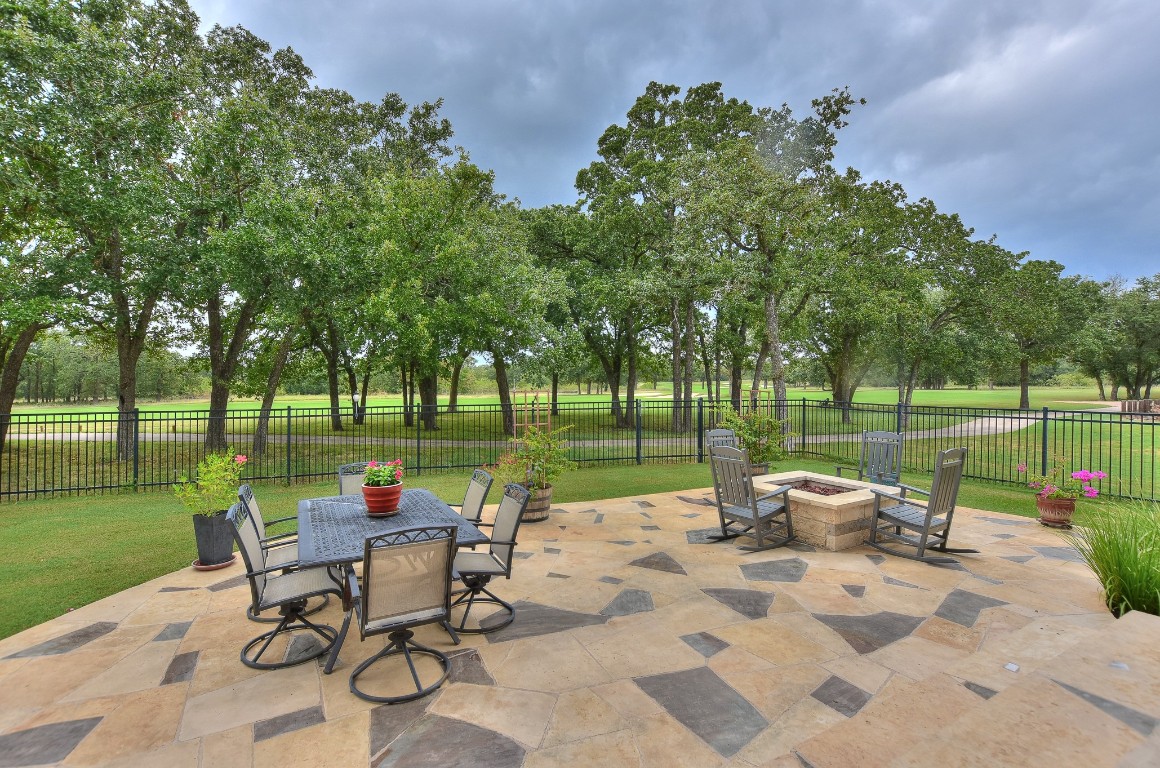 a view of a table and chairs in the garden