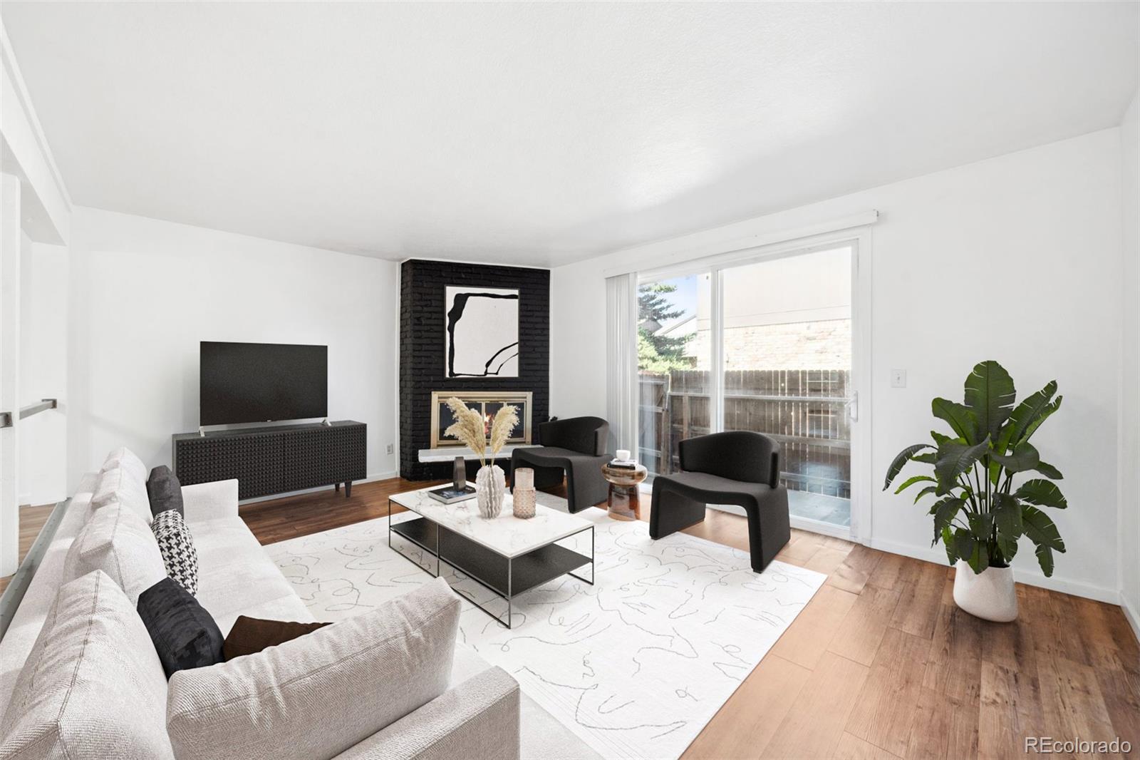 a living room with furniture a window and a flat screen tv