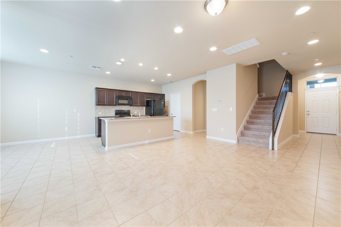 a view of kitchen with sink and refrigerator