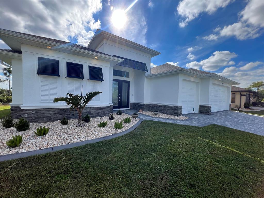 a front view of house with yard and outdoor seating