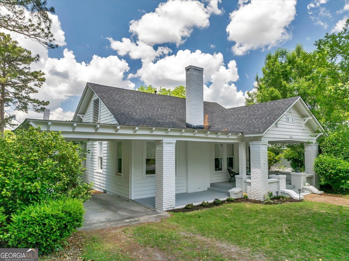 a front view of a house with garden