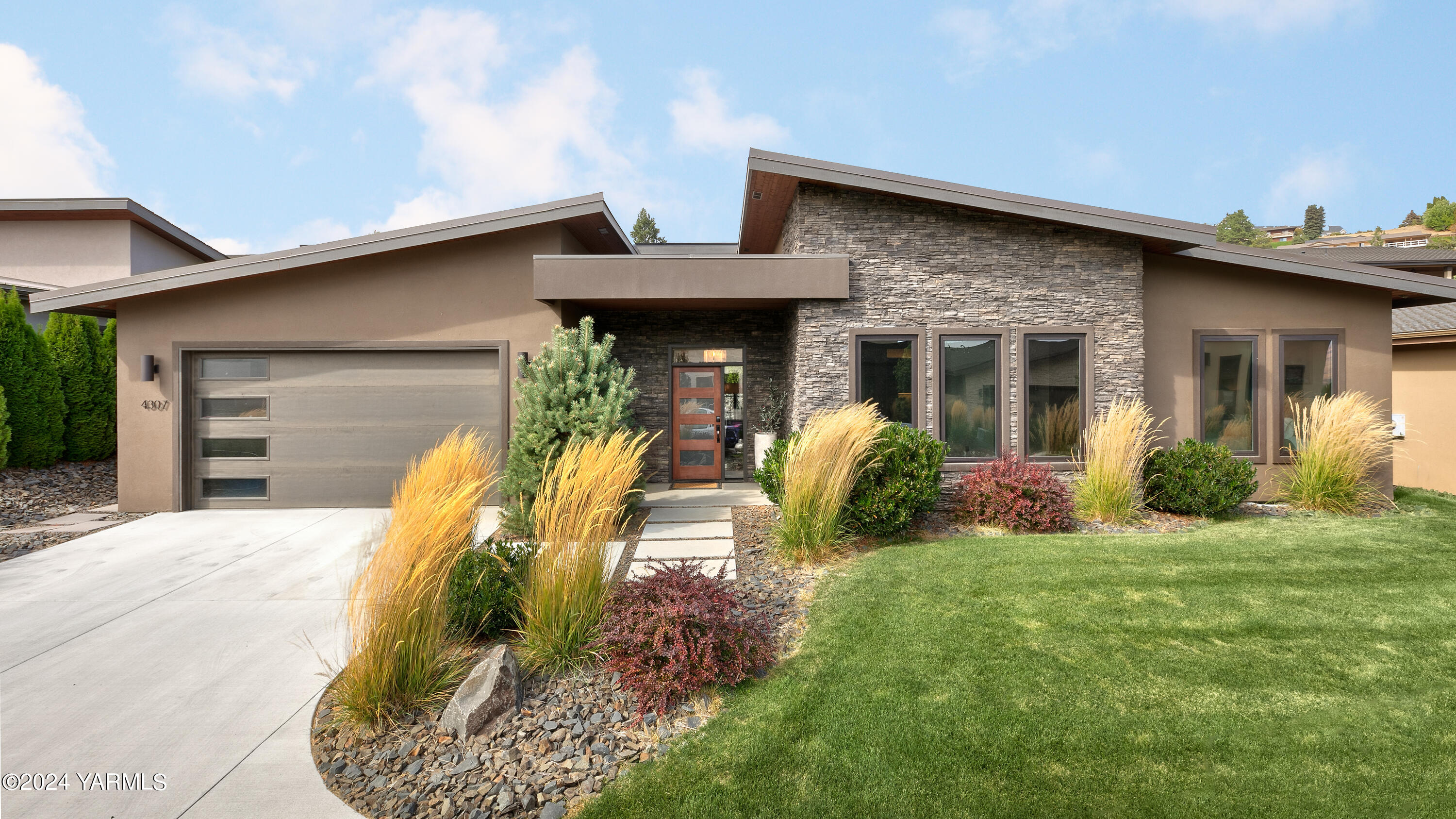 a view of a house with a yard patio and fire pit