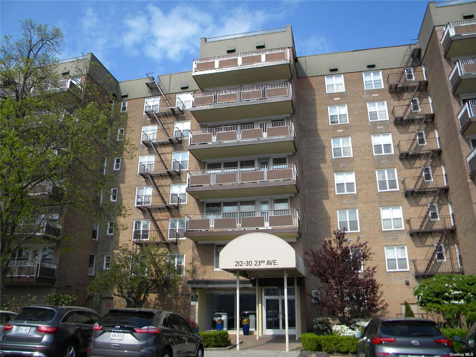 a front view of a building with parking space