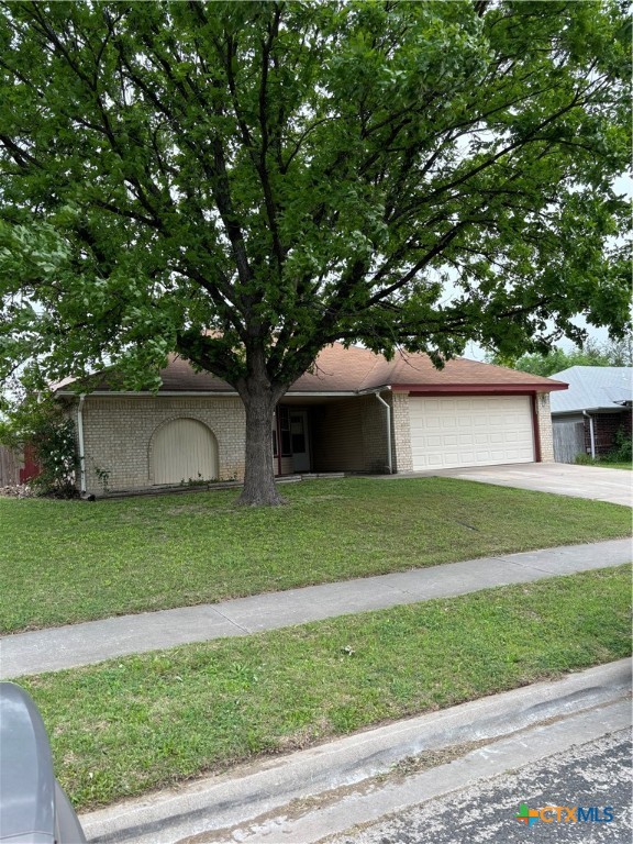 a front view of a house with a garden and yard