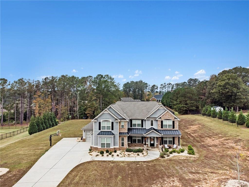 a view of a big house with a big yard and large trees