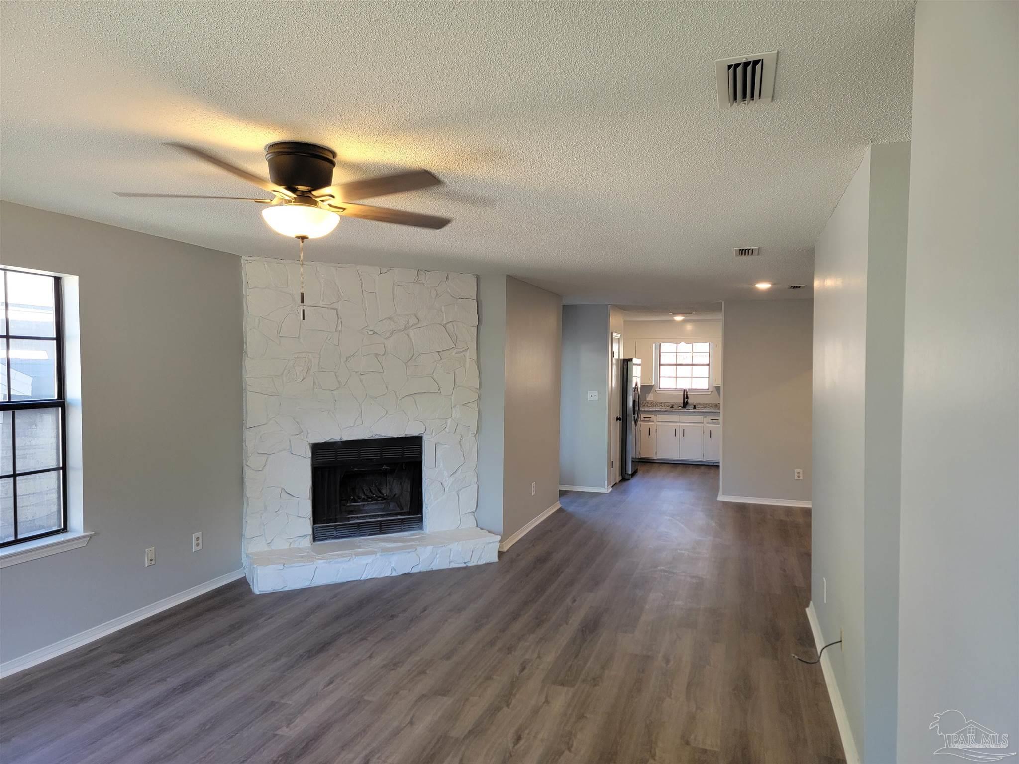 a view of a room wooden floor and a kitchen