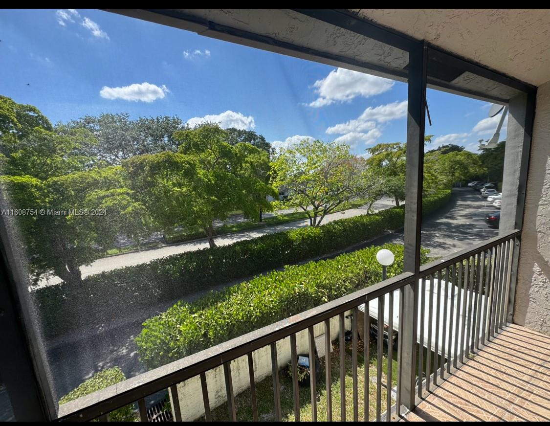 a view of a green yard from a balcony