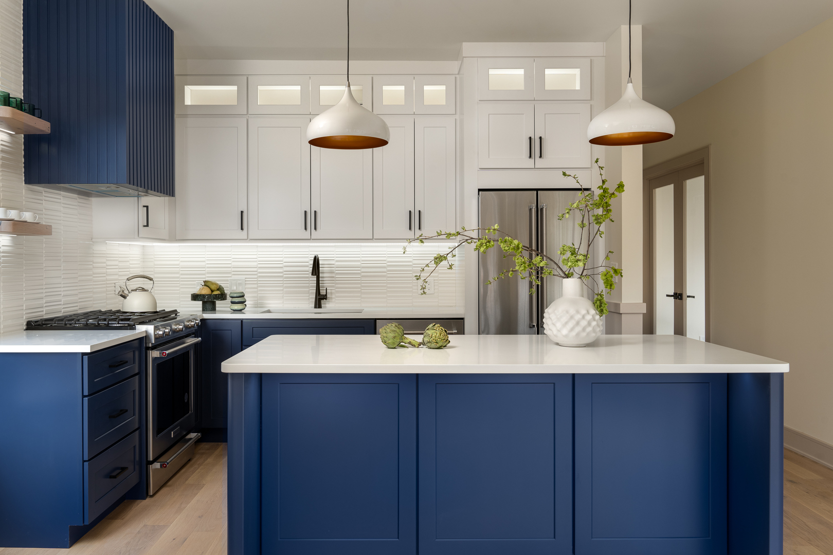 a kitchen with a sink a stove and chairs