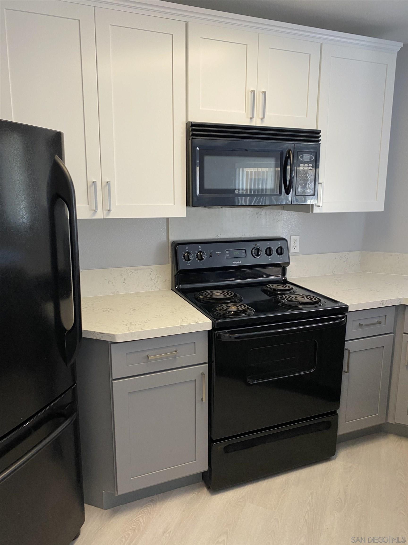 a stove top oven sitting inside of a kitchen