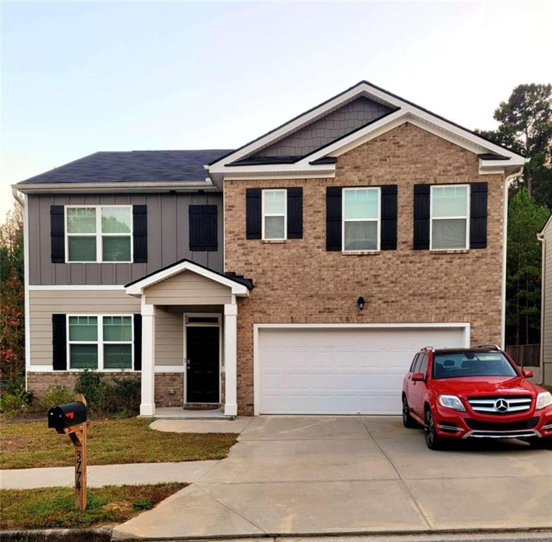 a front view of a house with parking space