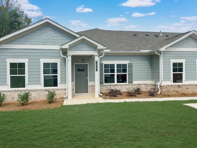 a front view of a house with a yard and outdoor seating