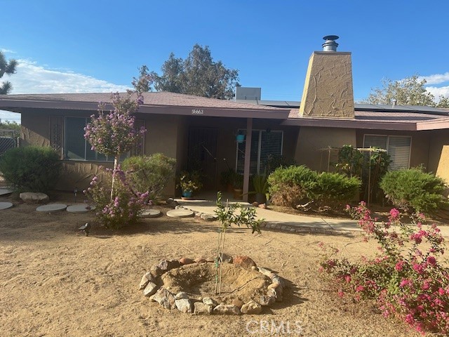 a view of a house with a yard and sitting area