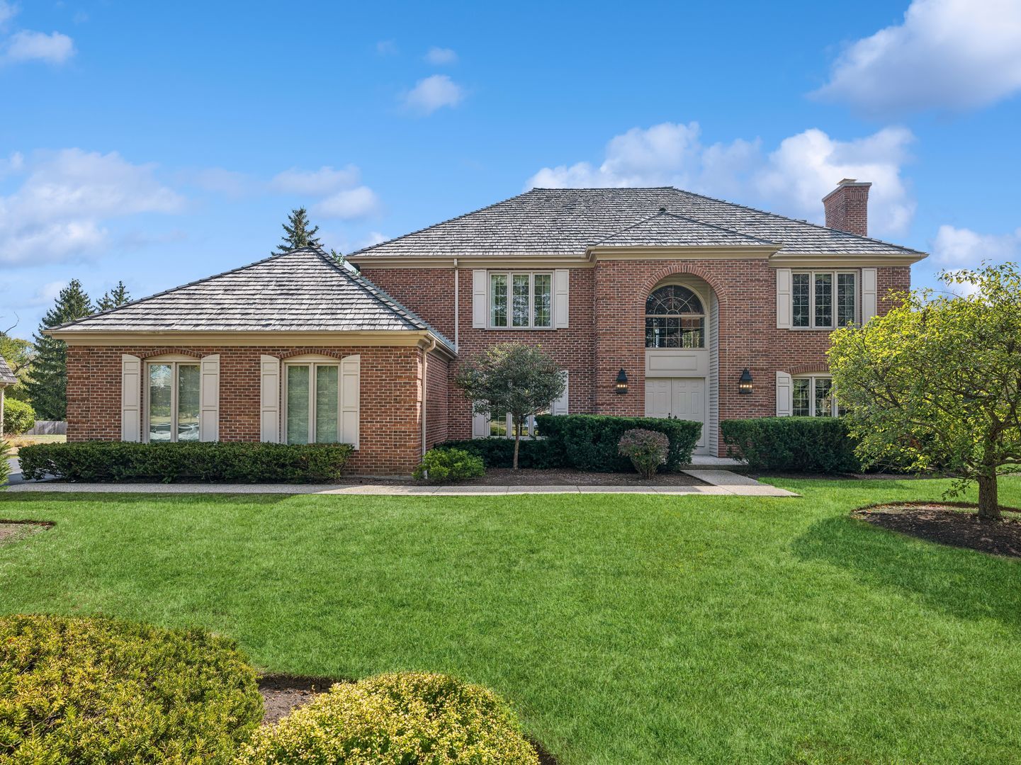 a front view of a house with a yard