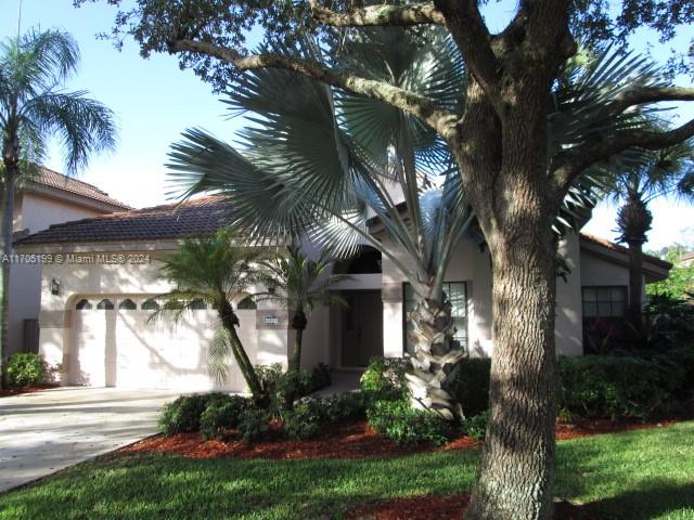 a front view of a house with a garden