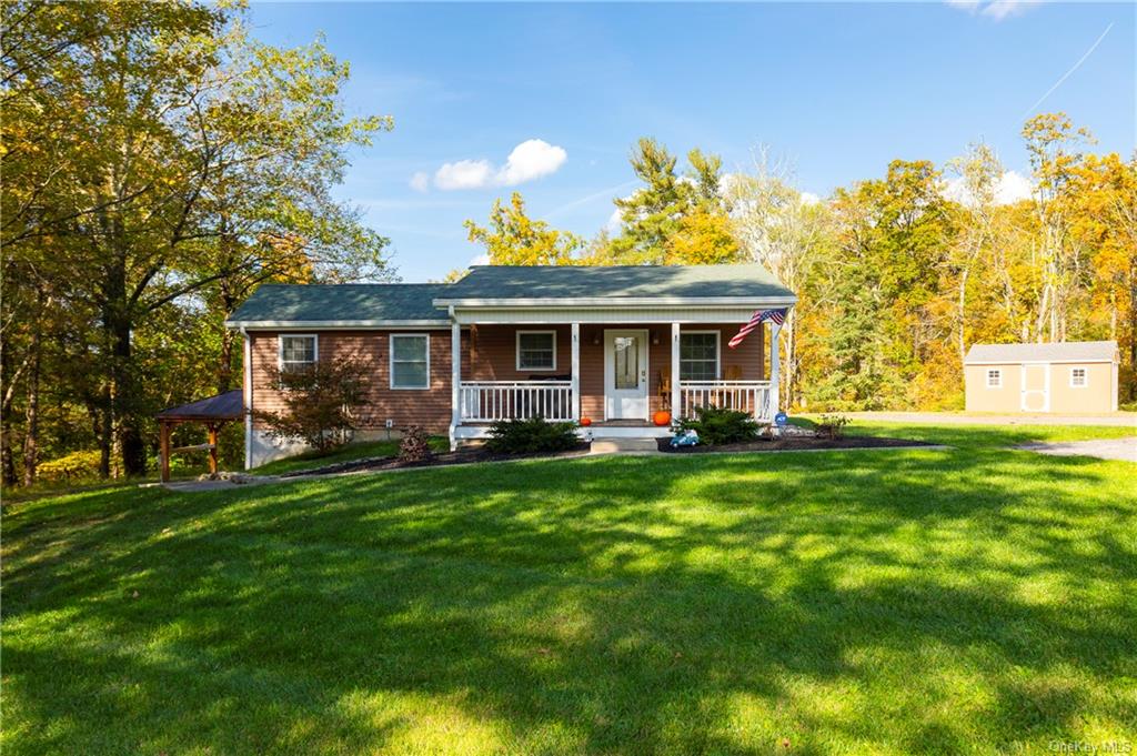 a view of a house with a backyard porch and garden