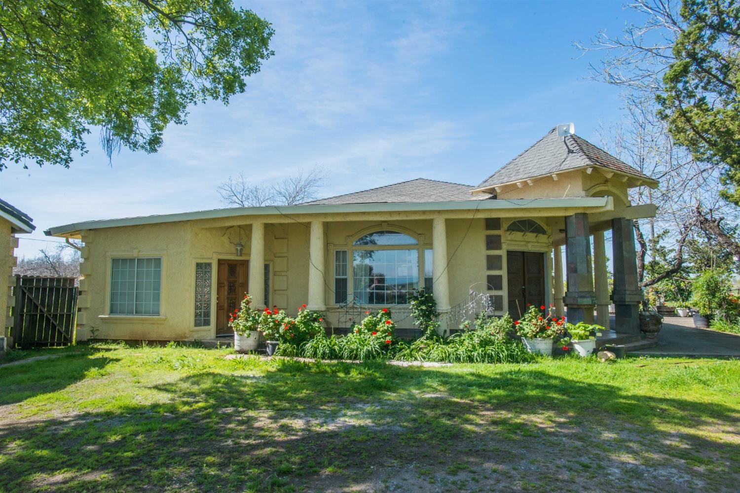 a front view of a house with garden